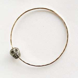 Carved pyrite skull bead slide across soldered bangle with hand-hammered texture. Pairs well with a variety of bracelet styles or worn alone.  Metal: 14kt Gold-Filled  Gauge: 14 gauge
