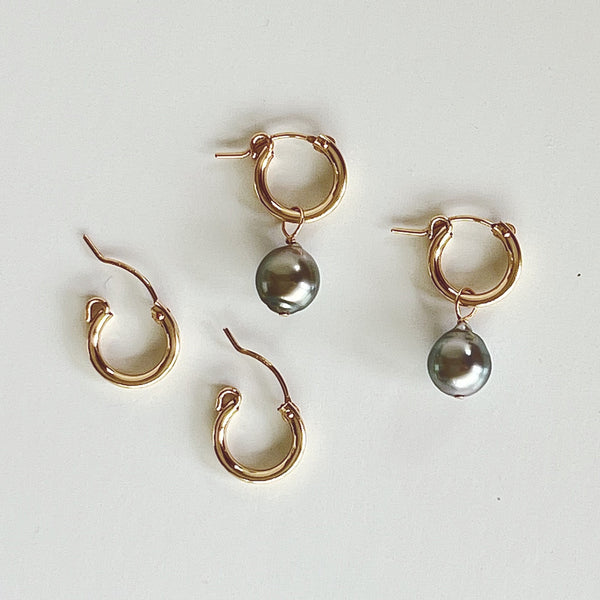 Tahitian pearls add-on understated glamour to huggie hoop earrings ideal for everyday.  1" drop, 3/8" width, 9mm pearls aprox. Removable pearl dangle 14kt Goldfill/Tahitian pearls Snap post enclosure