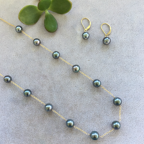 This classic set pairs a thirteen 10-12mm Tahitian pearl station necklace with matching pearls on classic lever-back earrings. A set to be treasured forever.  Length: 18"  Pearl Size: 10-12mm  Metal: 14K Gold-Filled